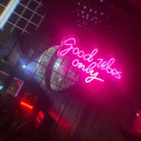 Good Vibes Only logo in pink lighting