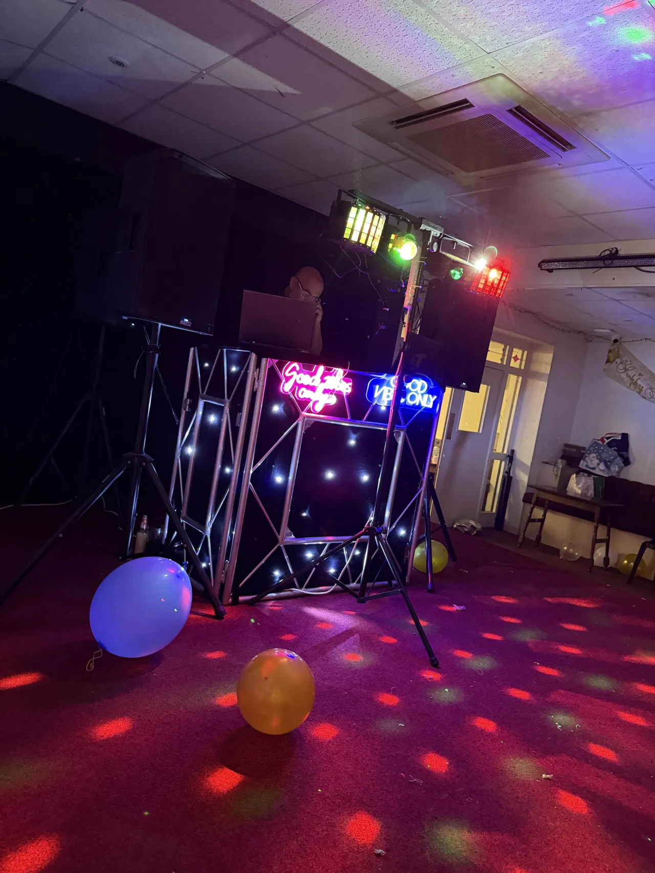 A photo of Jon standing behind the decks at an event