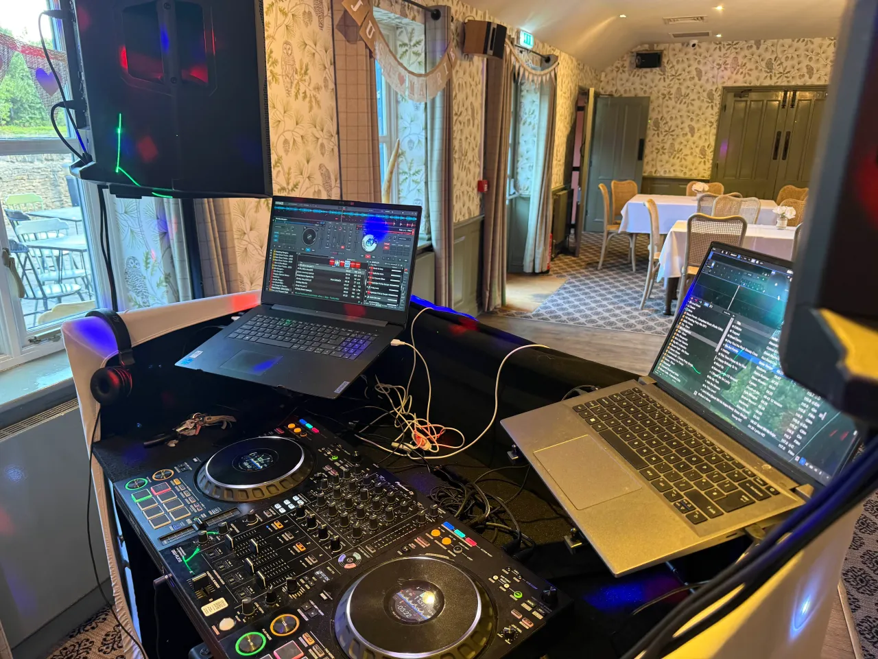 A close up photo of DJ decks and a laptop at an event
