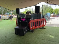 Jon at an event standing behind the DJ decks