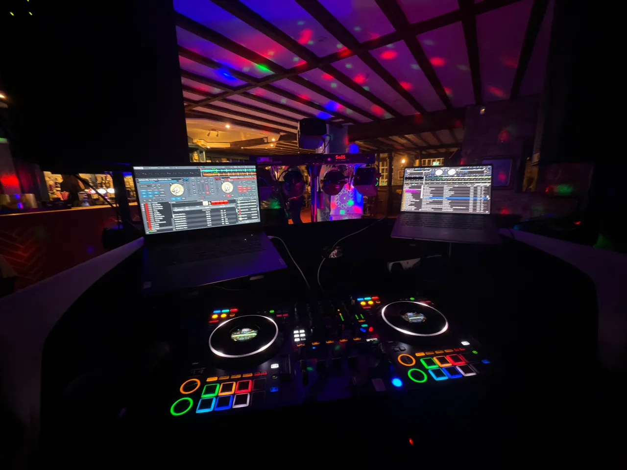 A close up photo of DJ decks with dark lighting